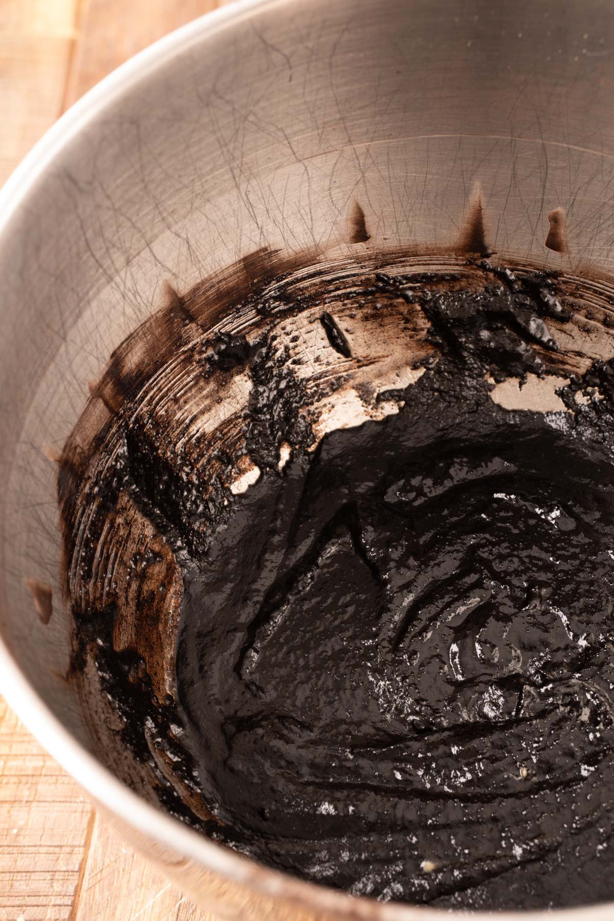 Black cocoa cookie dough beginning to be mixed in a stand mixer bowl.