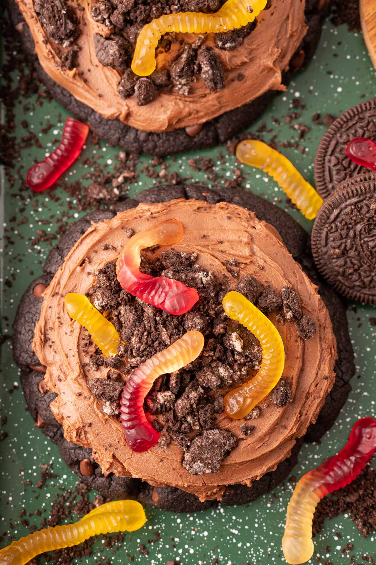 Overhead photo of a Dirt Cake Cookie on a green sheet pan.