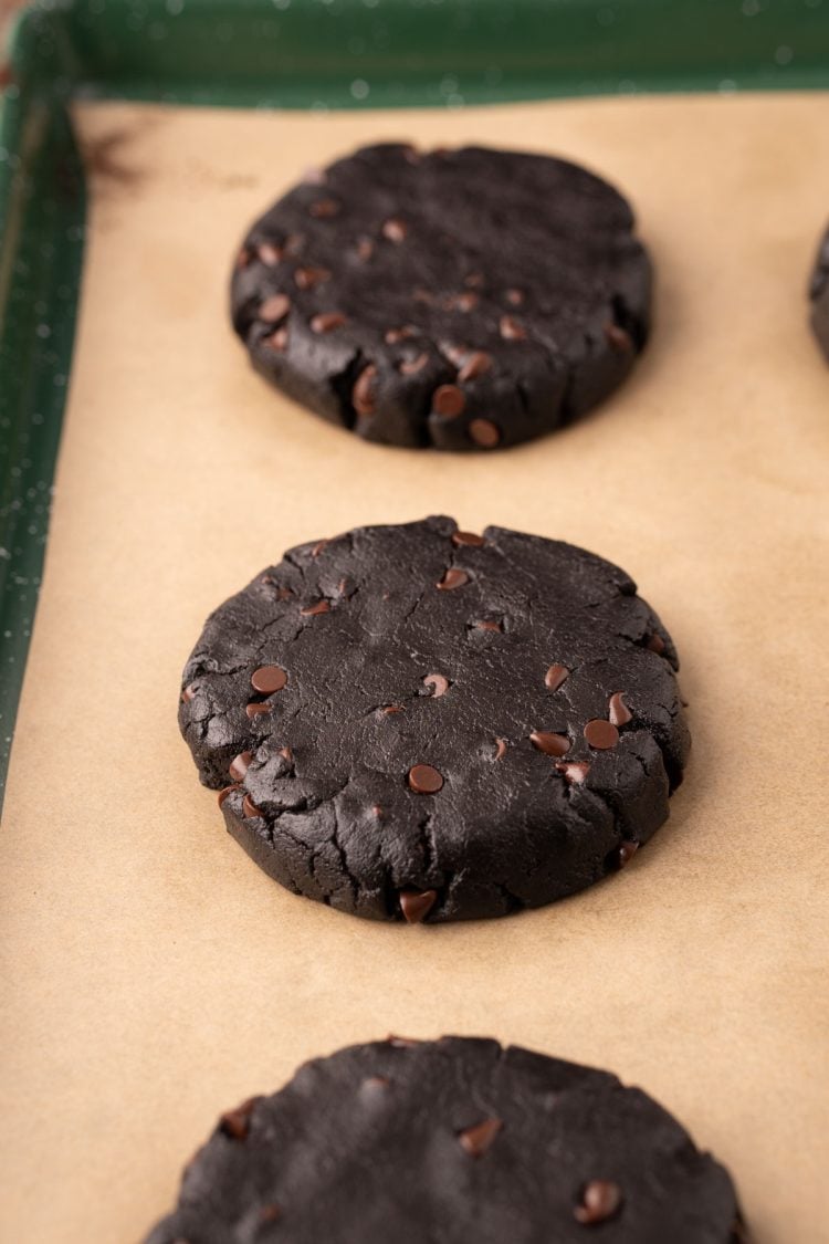 Black cocoa cookies on a baking pan ready to bake.