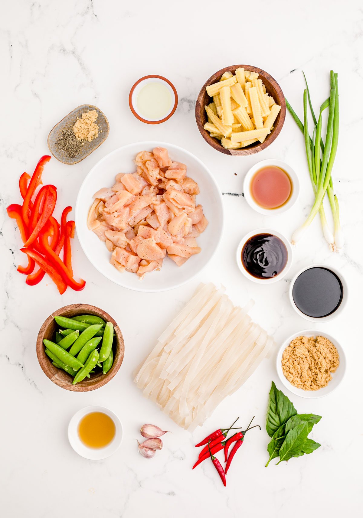 Overhead photo of drunken noodles on a marble counter.