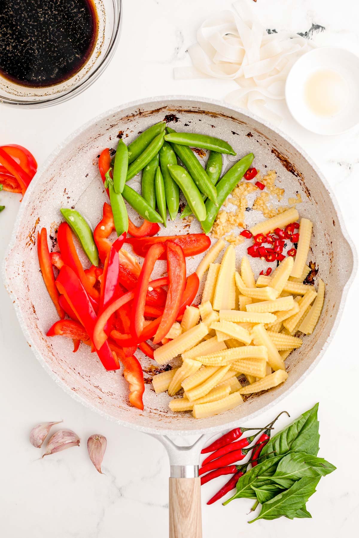 Veggies added to a skillet.