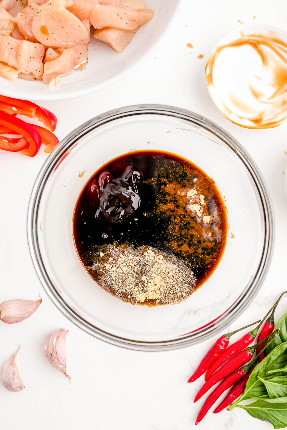 Ingredients to make sauce for drunken noodles in a glass mixing bowl.