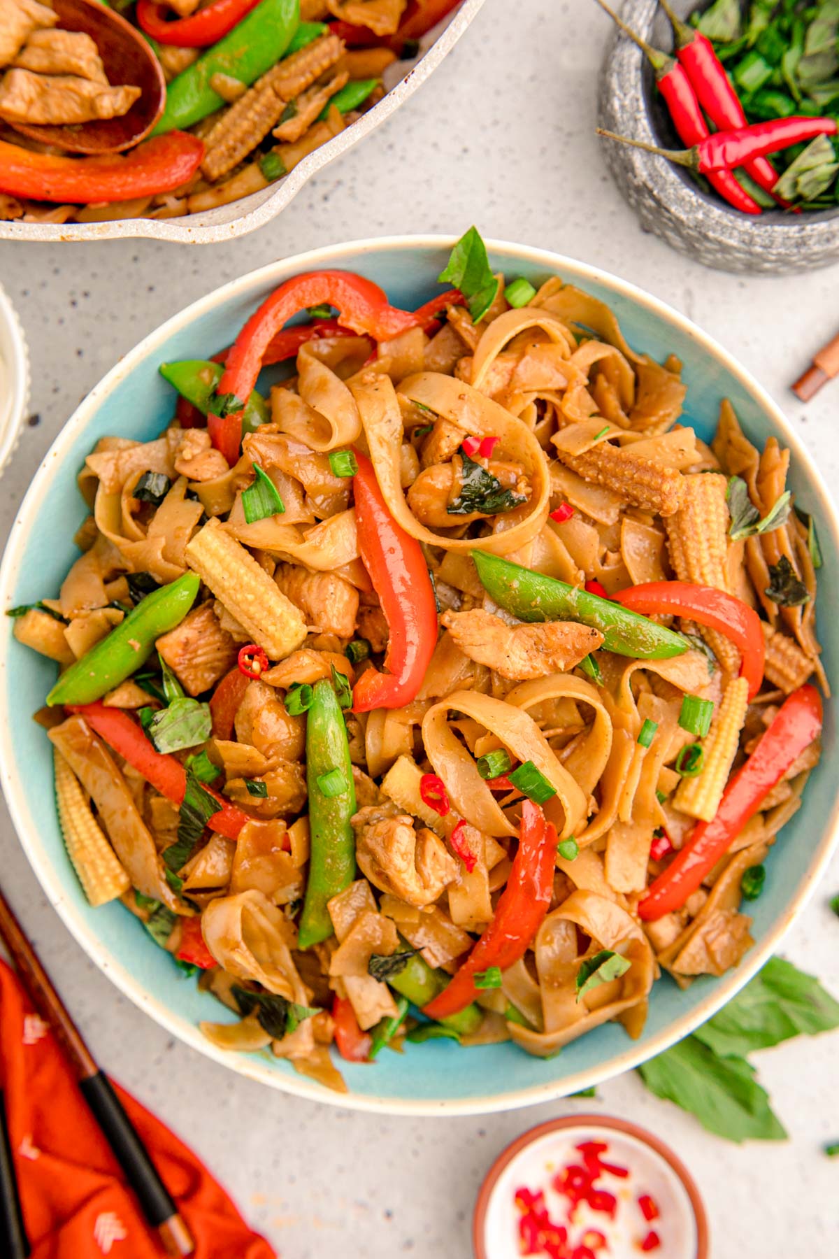 Overhead photo of a blue bowl filled with drunken noodles.