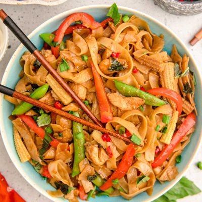 Overhead photo of a blue bowl filled with drunken noodles.