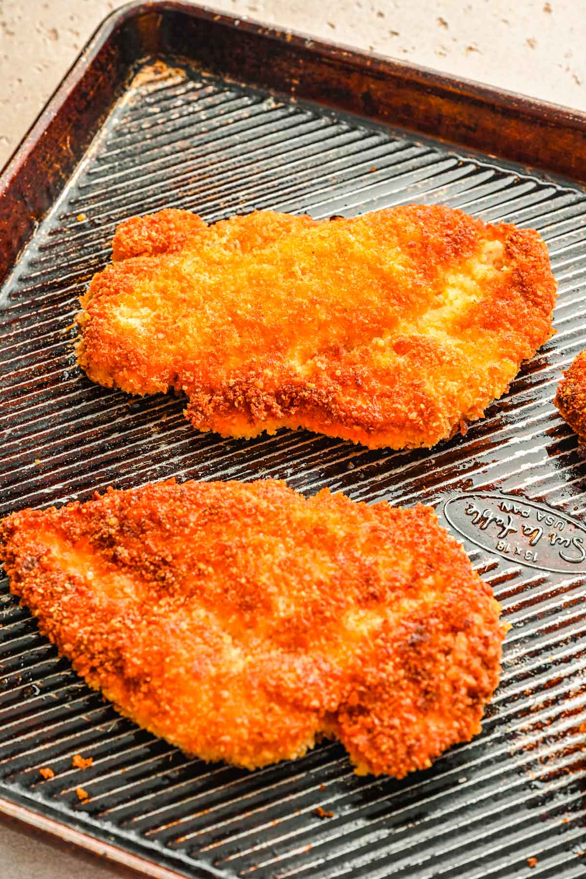 Panko breaded chicken on a sheet pan.