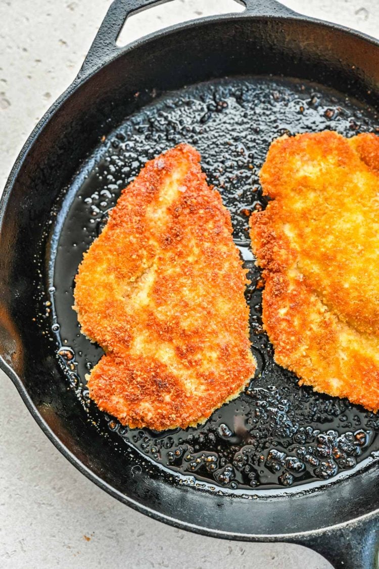 Panko crusted chicken in a skillet.