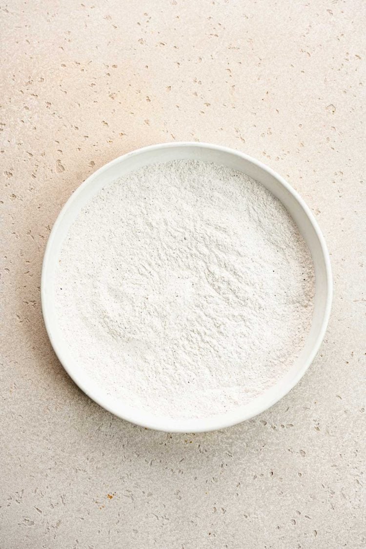 Flour and seasonings in a white bowl.