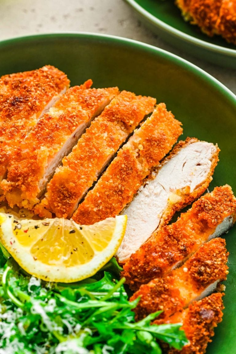 Overhead photo of panko chicken in a green bowl with rice and greens.