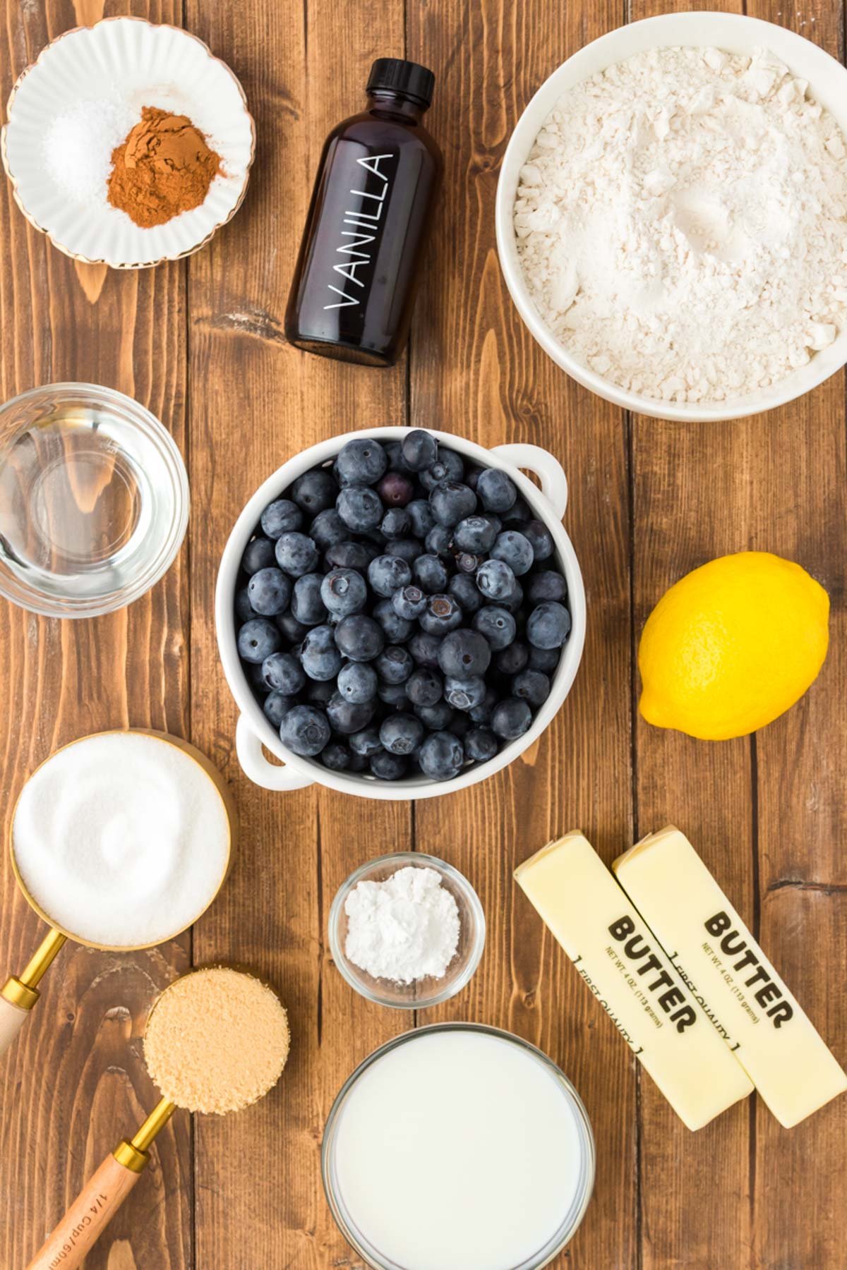 Ingredients to make blueberry cobbler on a wooden table.