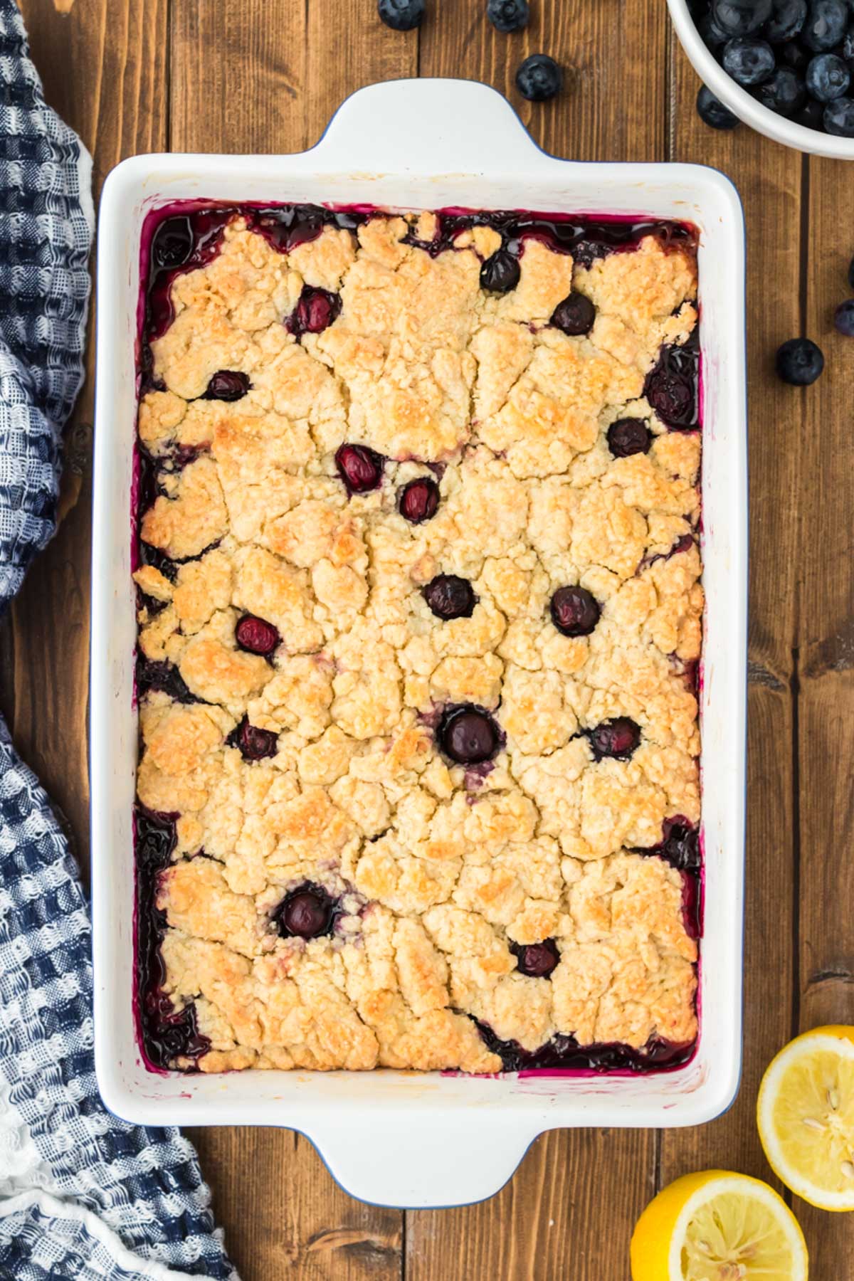 Overhead photo of blueberry cobbler on a wooden table.