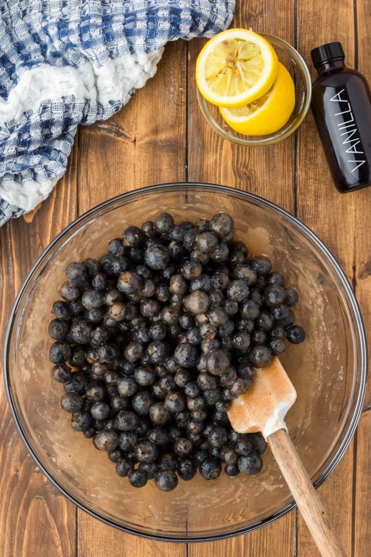 Blueberries in a glass bowl coated with a sugar and butter coating.