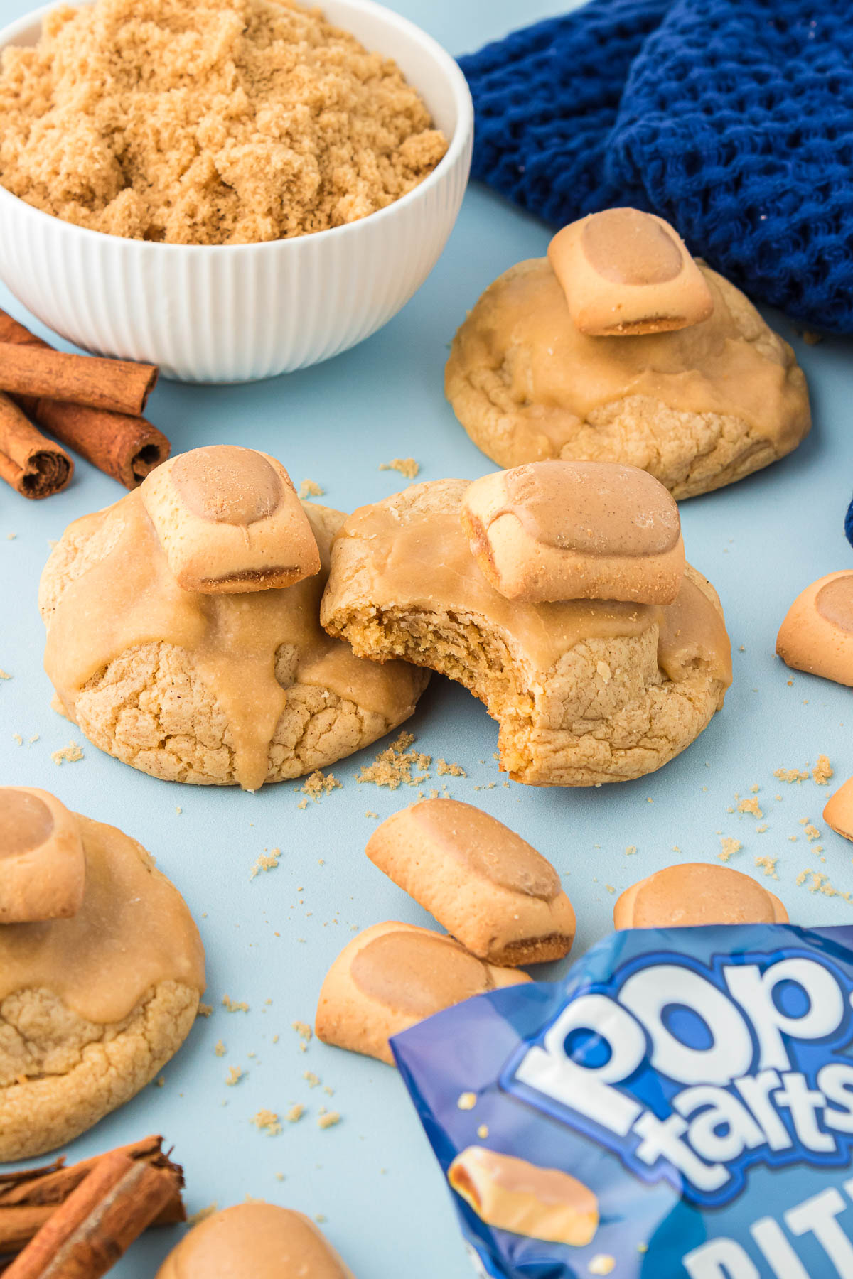 Brown sugar cinnamon cookie stuffed and topped with a mini pop tart on a blue surface.