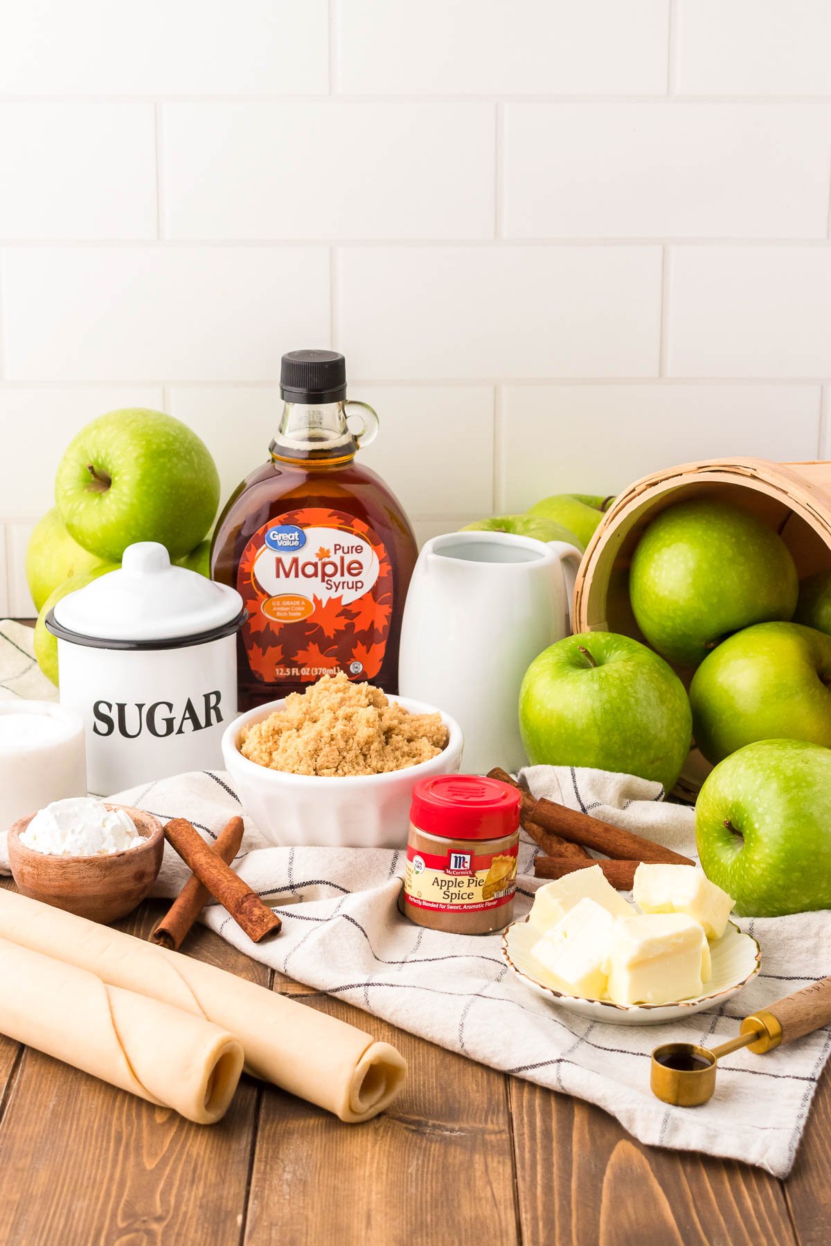 Ingredients to make apple pan dowdy on a wooden table.