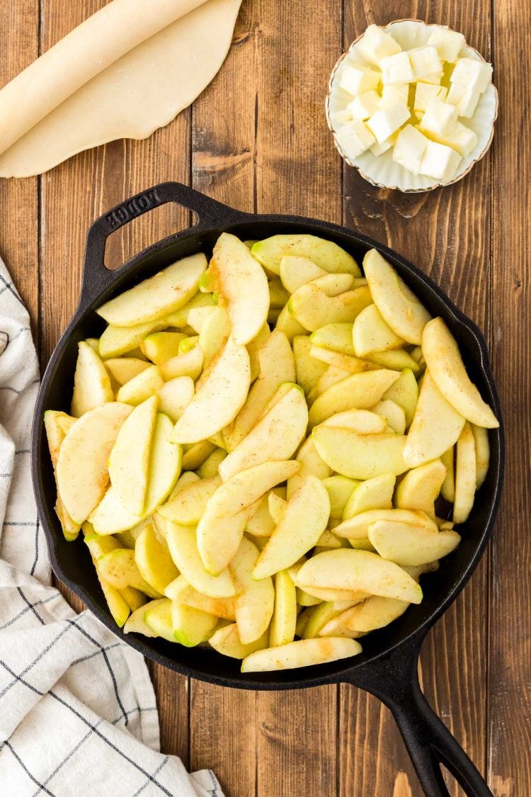 Cast iron skillet with apples in it.