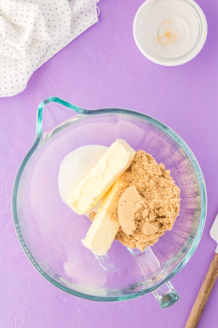 Butter and sugars in a glass mixing bowl.