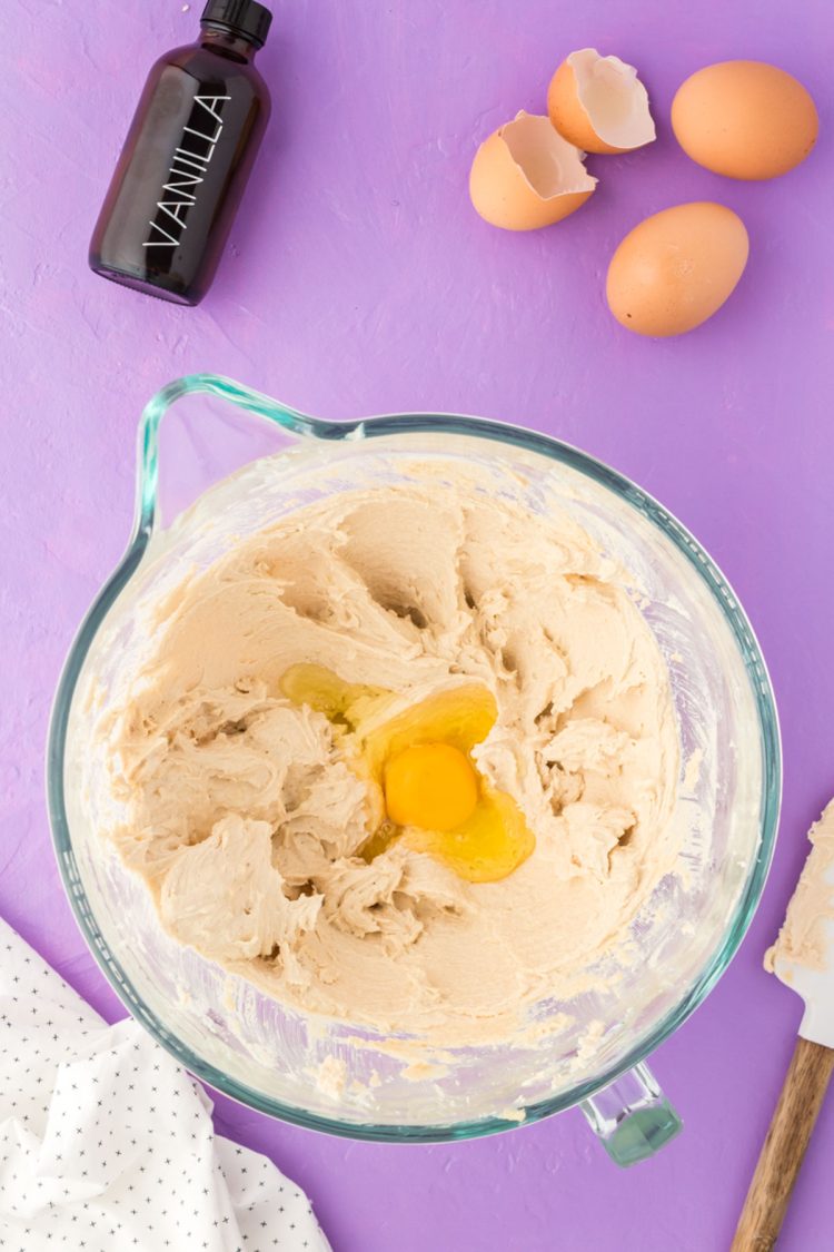 Egg being added to creamed butter and sugar.