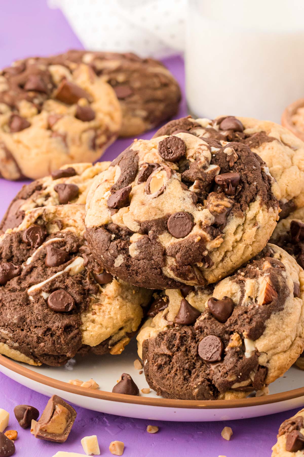 Vanilla and chocolate kitchen sink cookies on a plate.