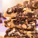 A stack of three kitchen sink cookies that have been cut in half.