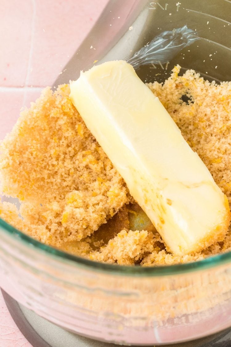 Butter added to a bowl with sugar.
