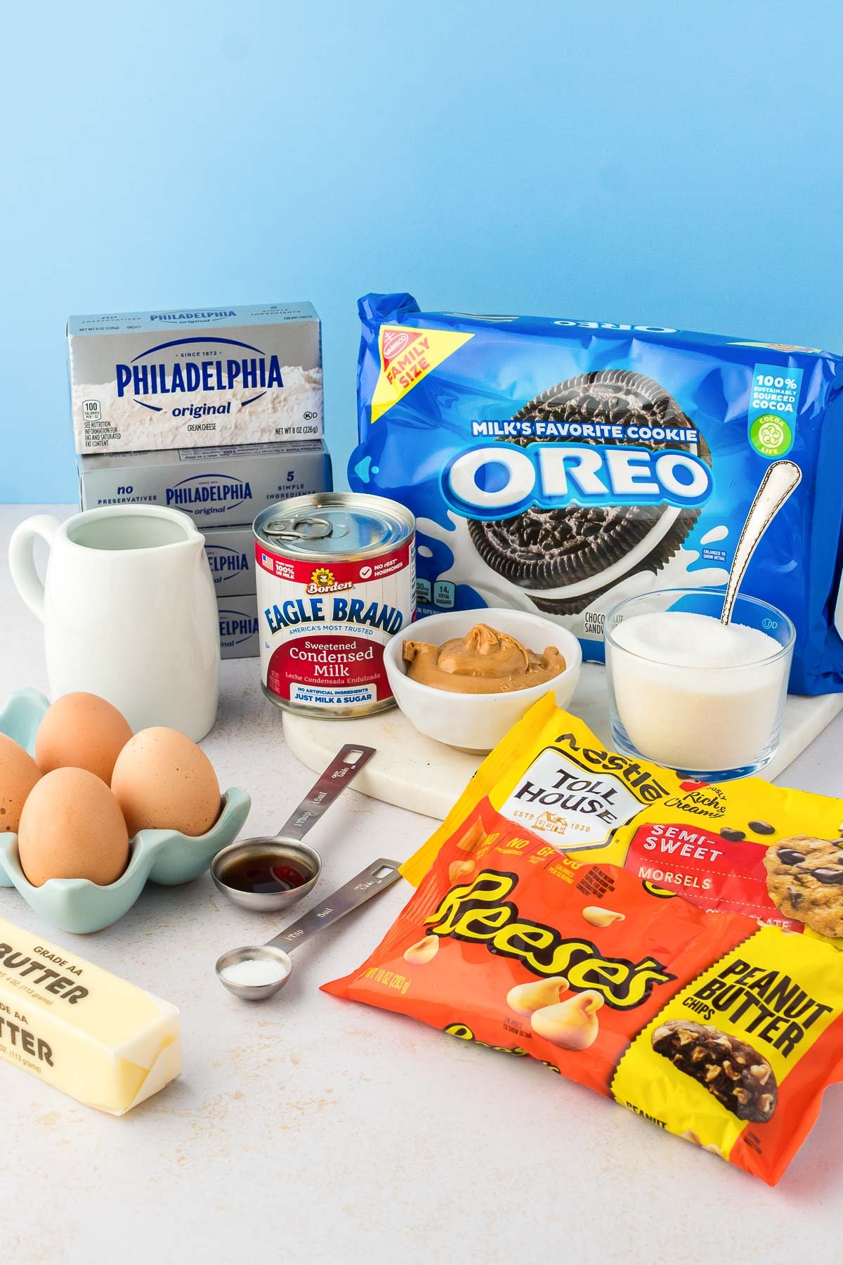 Ingredients to make peanut butter cheesecake on a table.