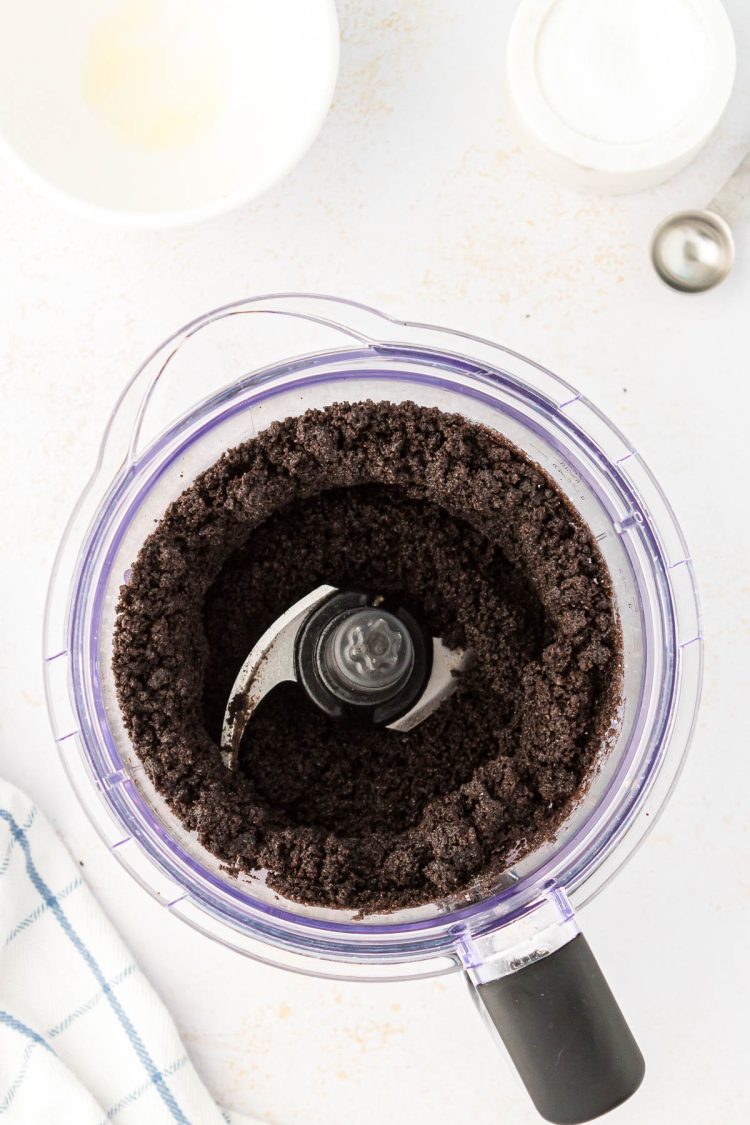 Oreo crumbs and butter in a food processor.