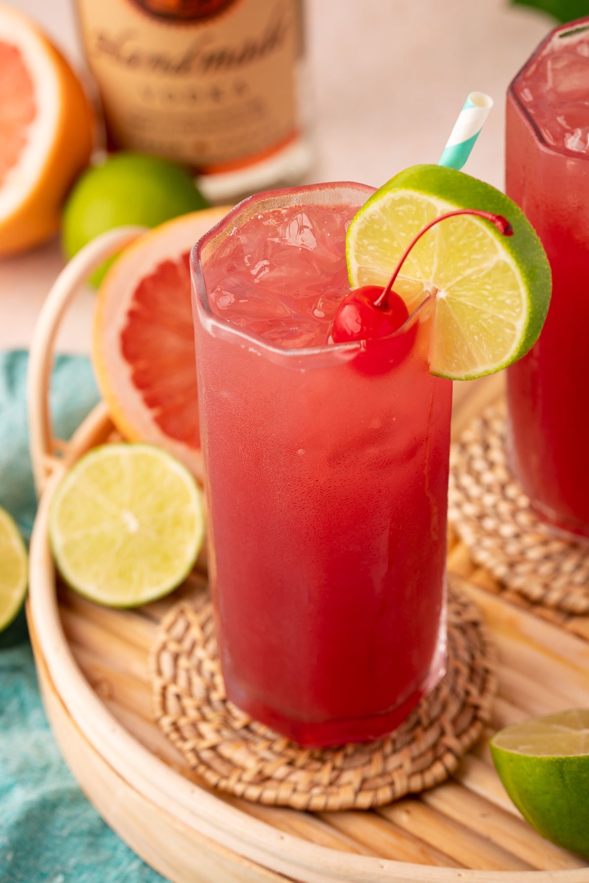 A glass of sea breeze cocktail on a serving tray.