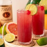 Two sea breeze cocktails on a rattan tray.