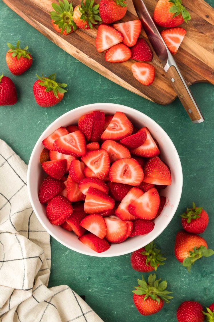 Strawberries prepped in a bowl.