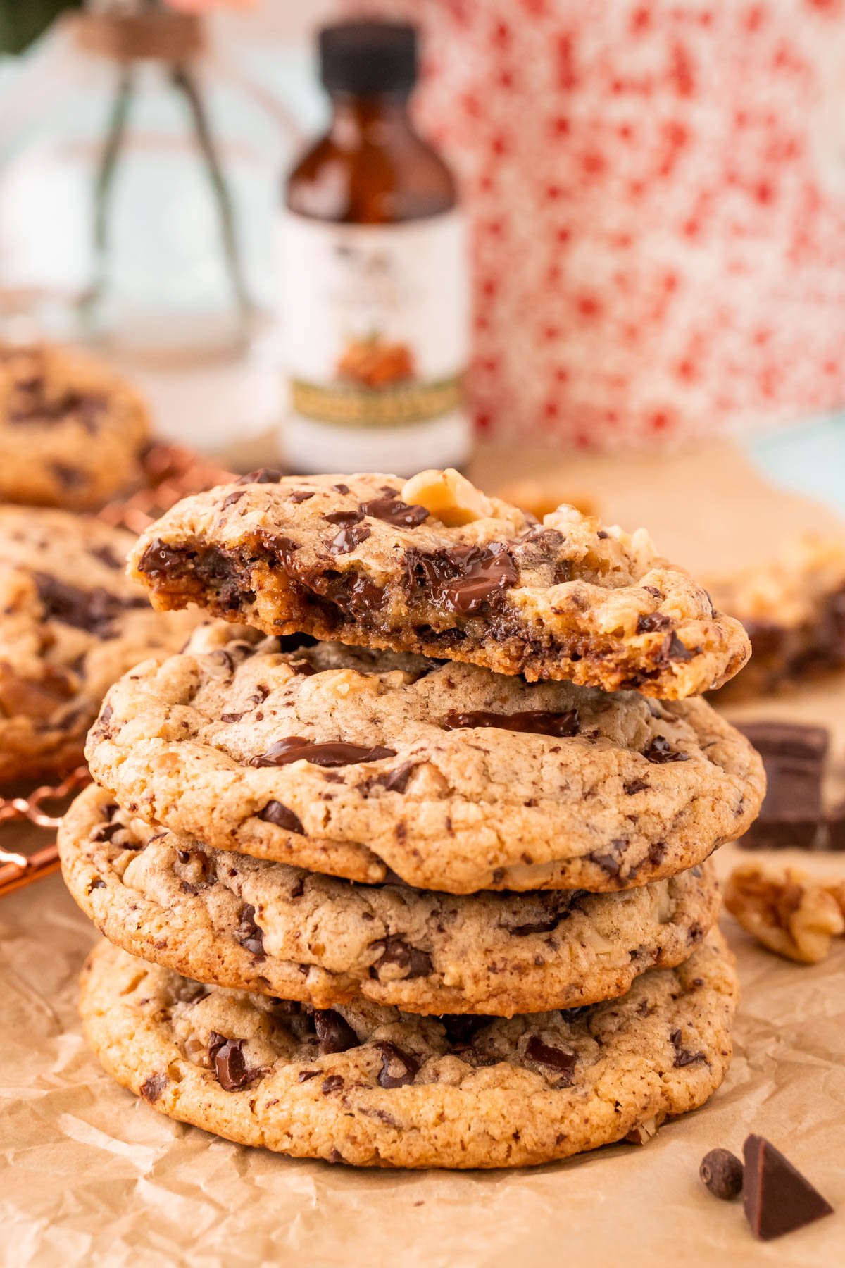 A stack of four cookies, the top one is broken in half.