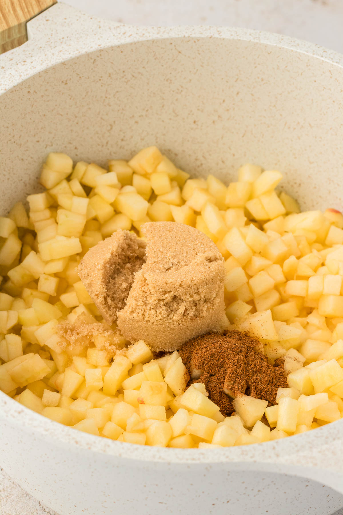 Chopped apples, brown sugar, and cinnamon in a small saucepan.