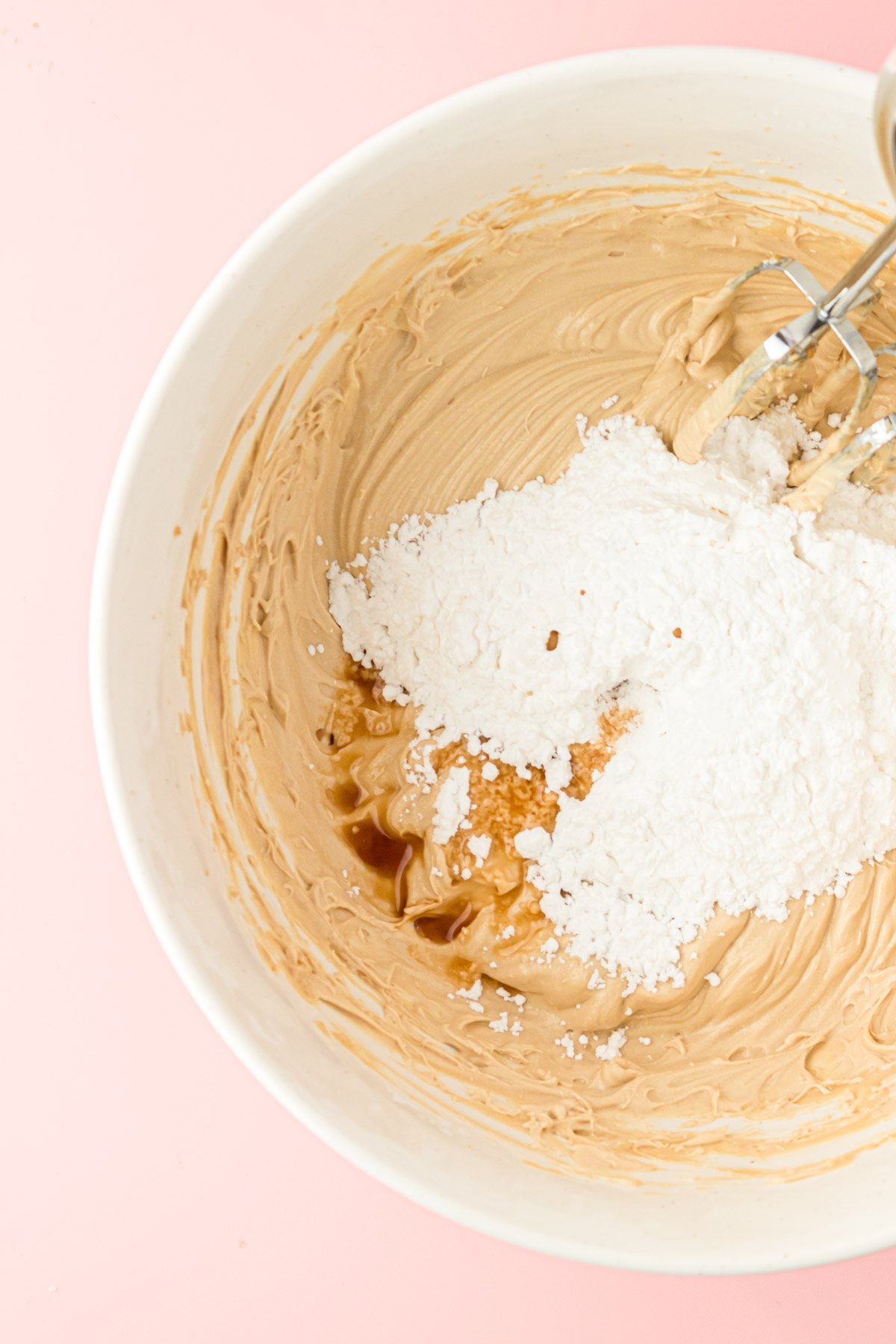 Vanilla and powdered sugar being added to cookie dough dip.