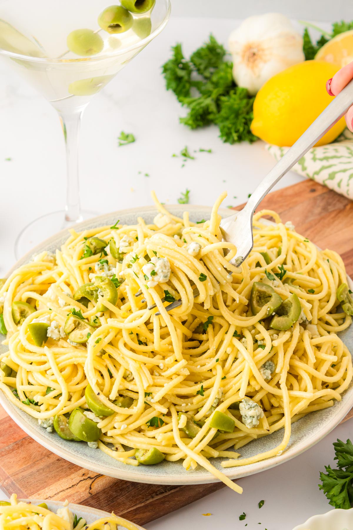 A fork taking a bite of tiktok dirty martini spaghetti.