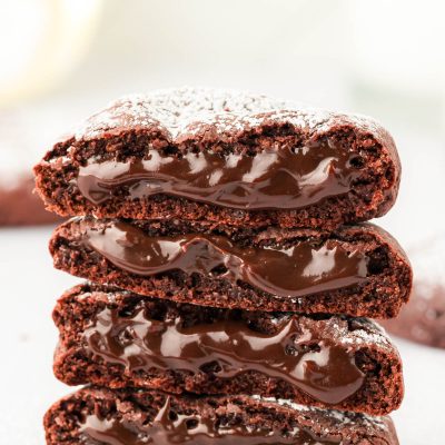 A stack of molten lava cake cookies on a white surface.