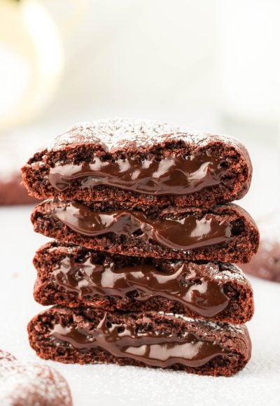A stack of molten lava cake cookies on a white surface.