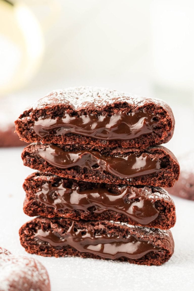 A stack of molten lava cake cookies on a white surface.