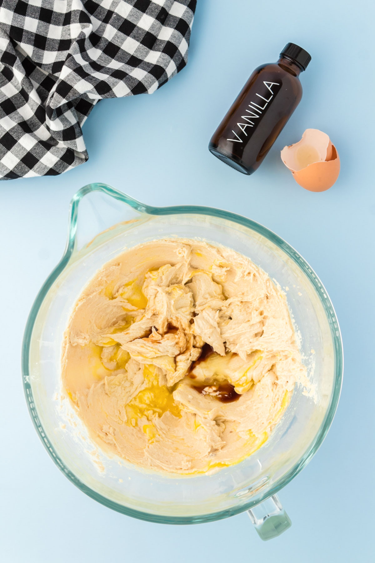 Eggs and vanilla being mixed into cookie dough.