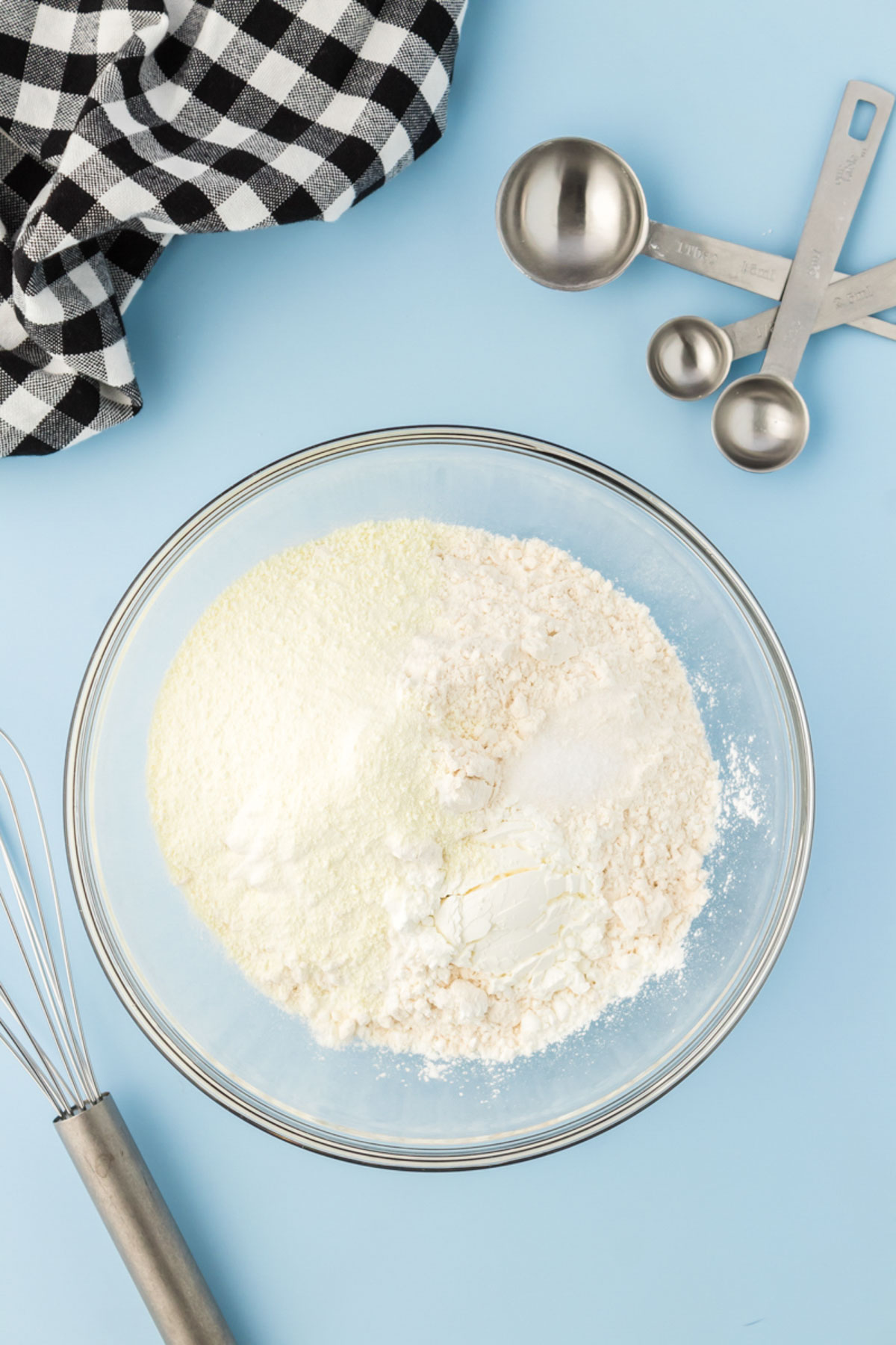 Dry ingredients for cookies being mixed in a mixing bowl.