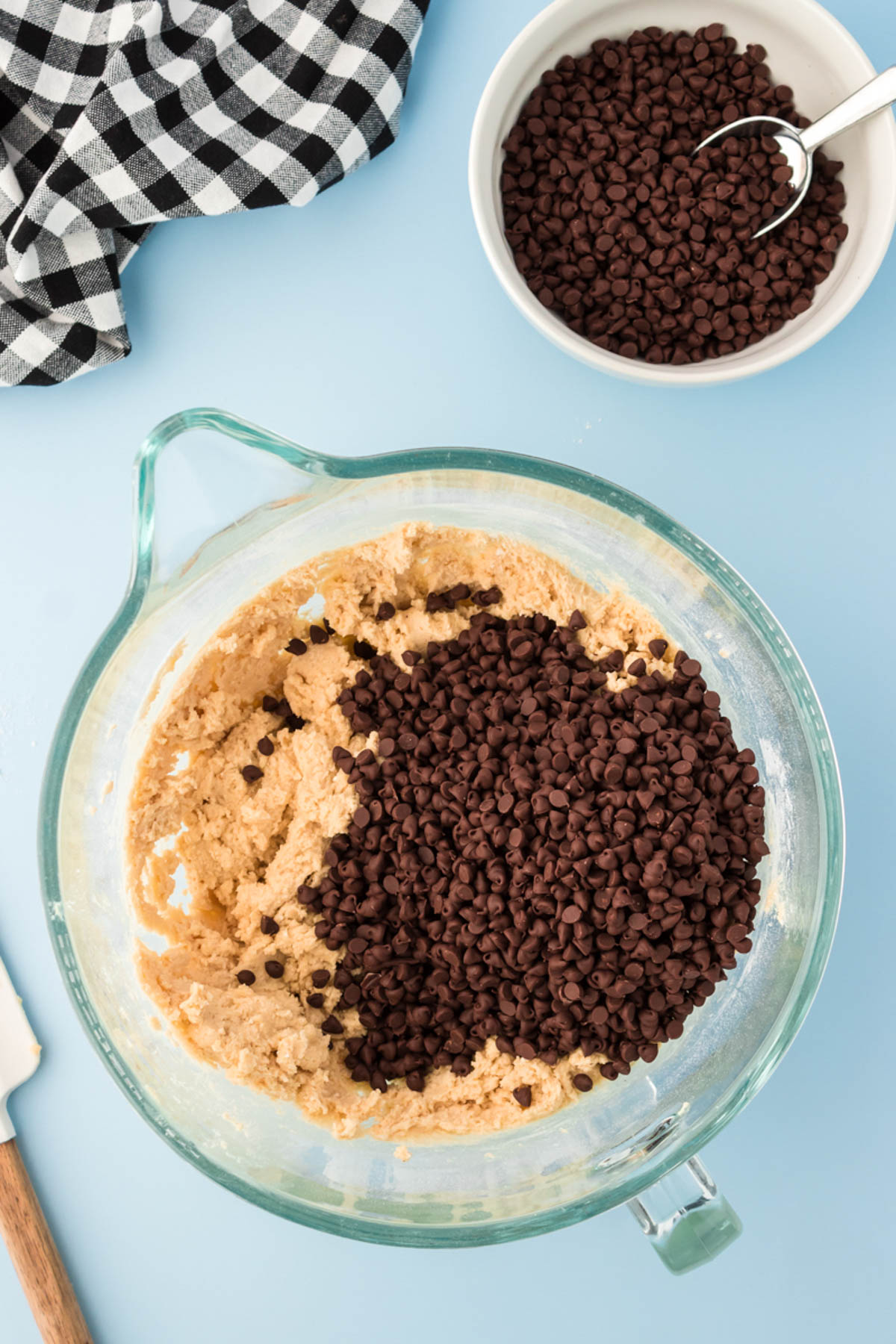 Mini chocolate chips being added to cookie dough.