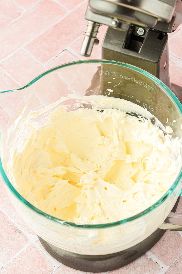 Cream cheese creamed in a glass mixing bowl.