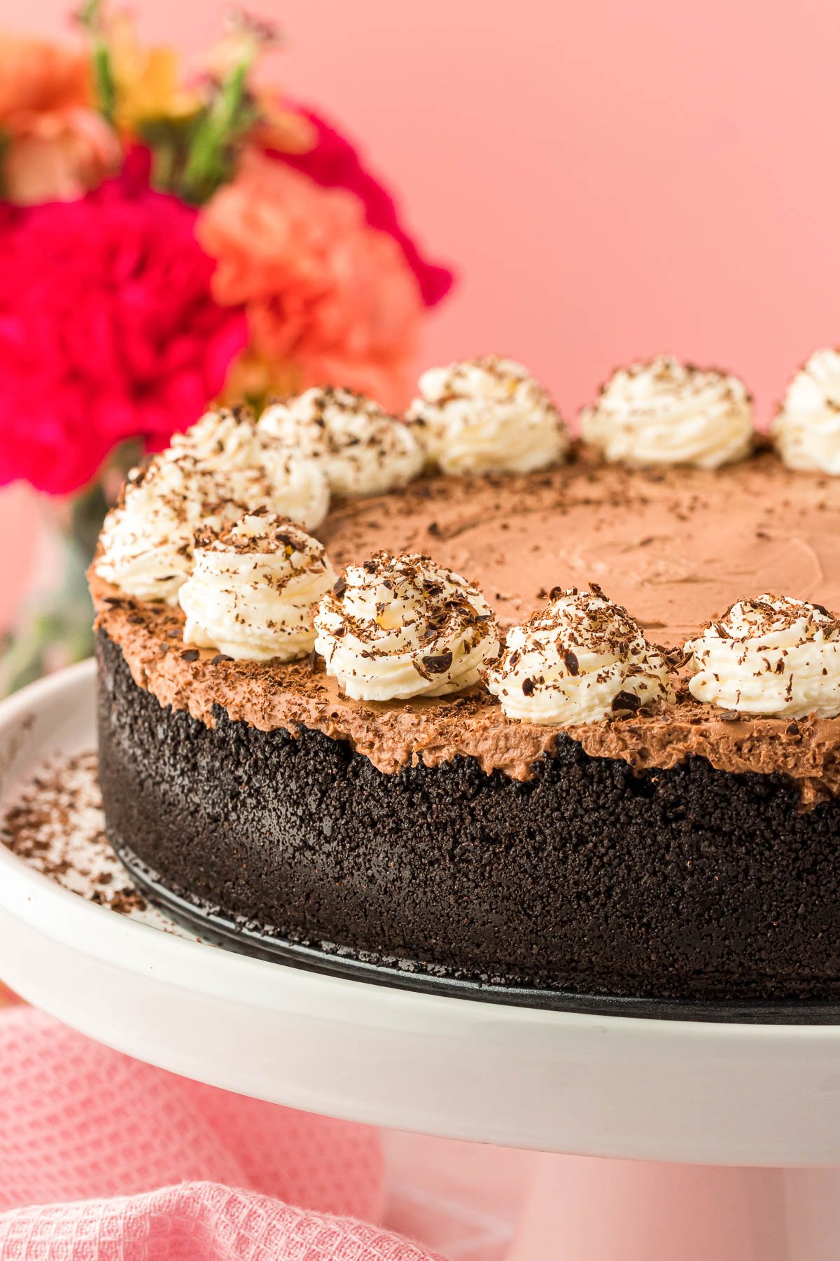 No Bake Chocolate Cheesecake on a white cake stand.