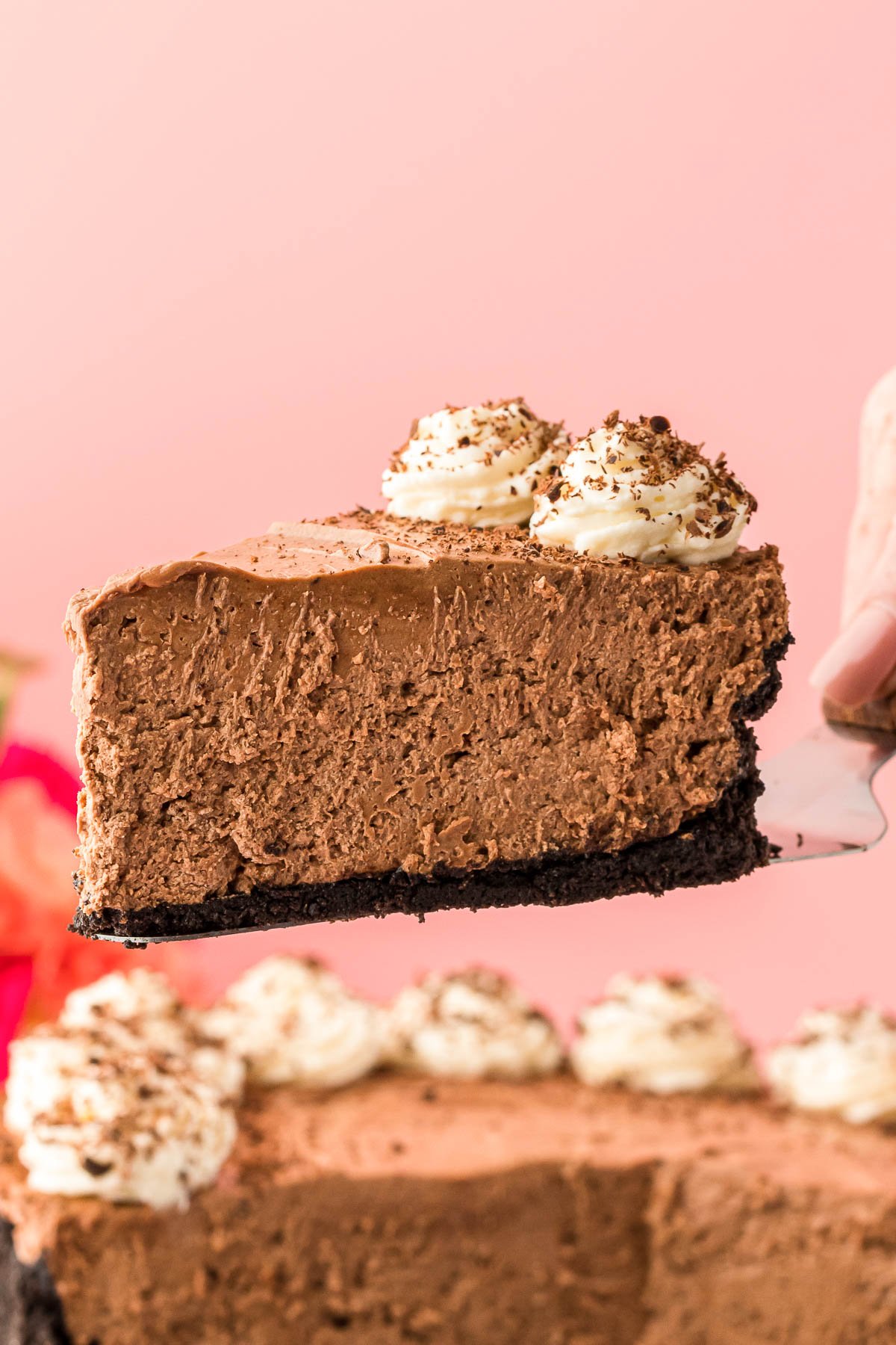 A slice of chocolate no bake cheesecake on a serving spatula.