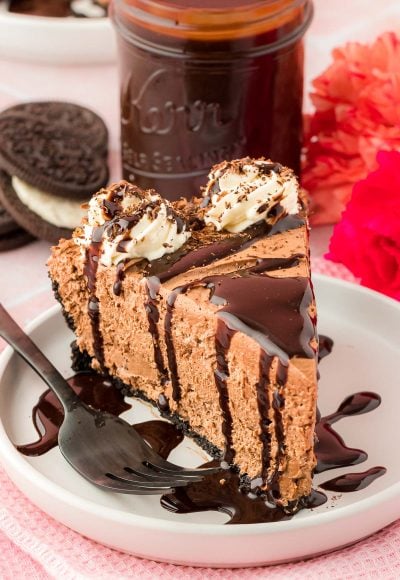 Close up of a slice of chocolate no bake cheesecake on a white plate.