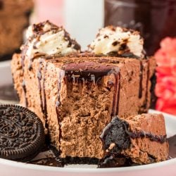 A slice of chocolate no bake cheesecake on a white plate.