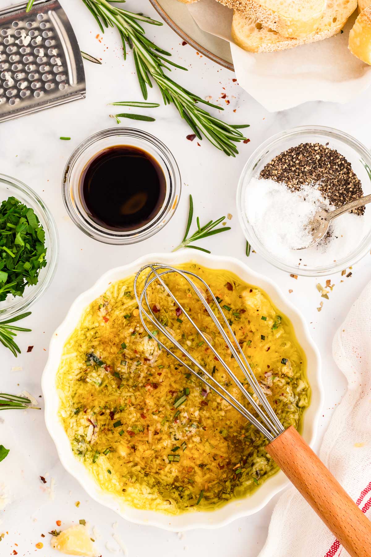 Olive oil bread dip being whisked together in a bowl.