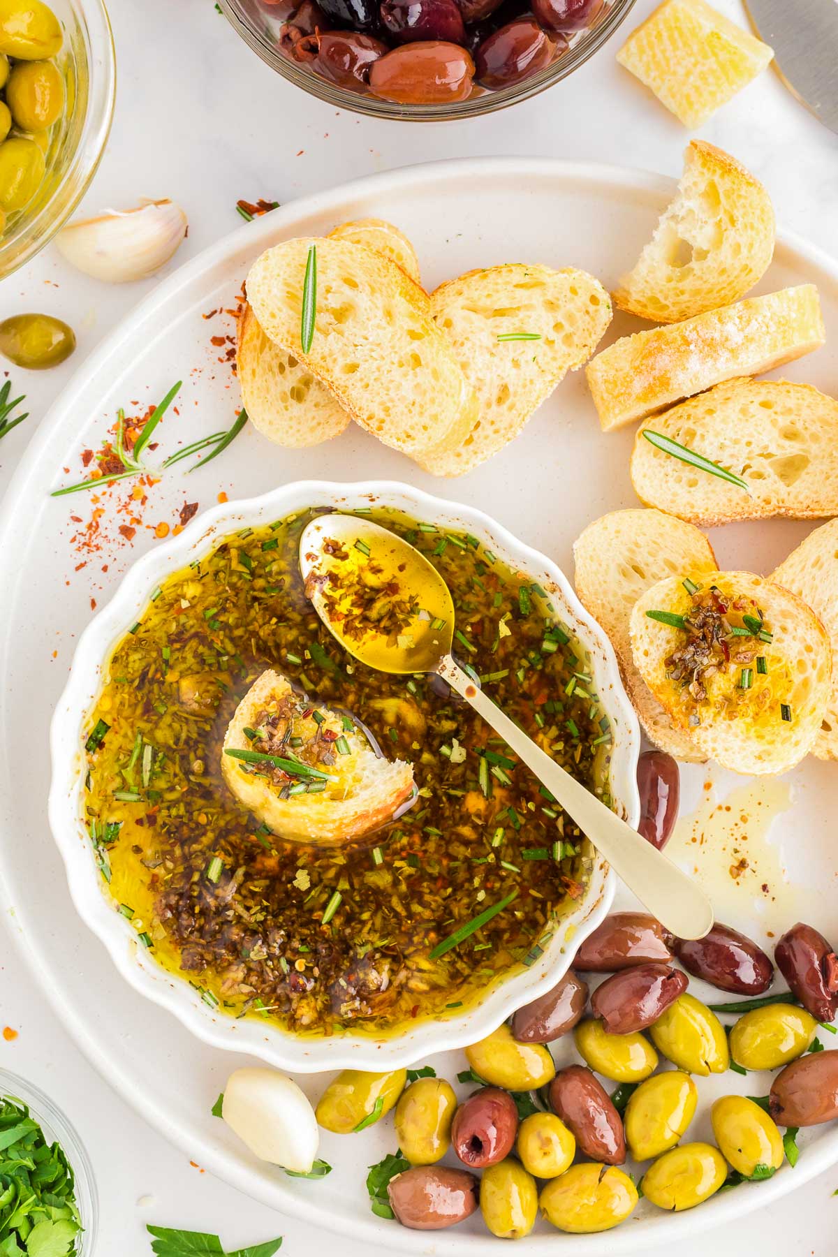 Overhead photo of bread being dipped in olive oil and spices.