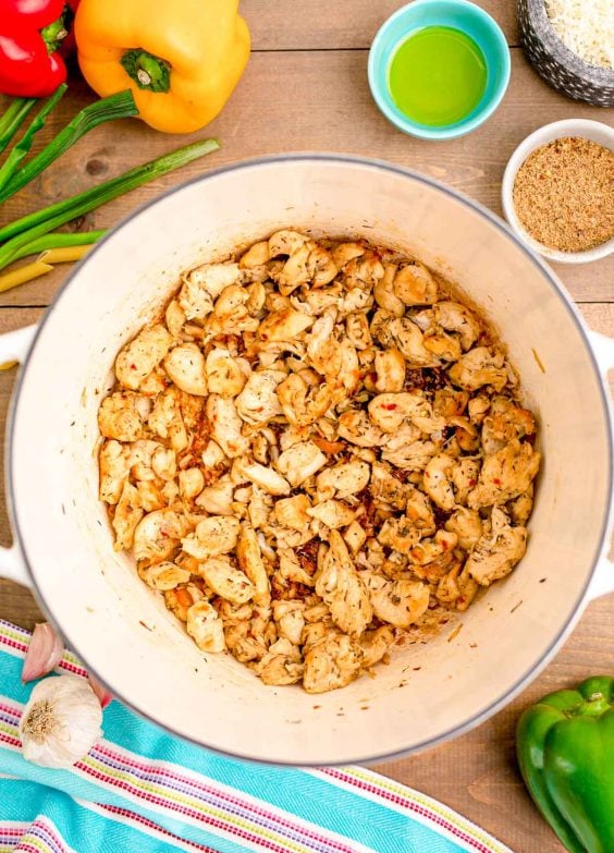 Chicken being cooked in a Dutch oven.