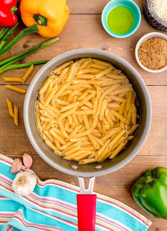 Penne pasta cooking in a pot.