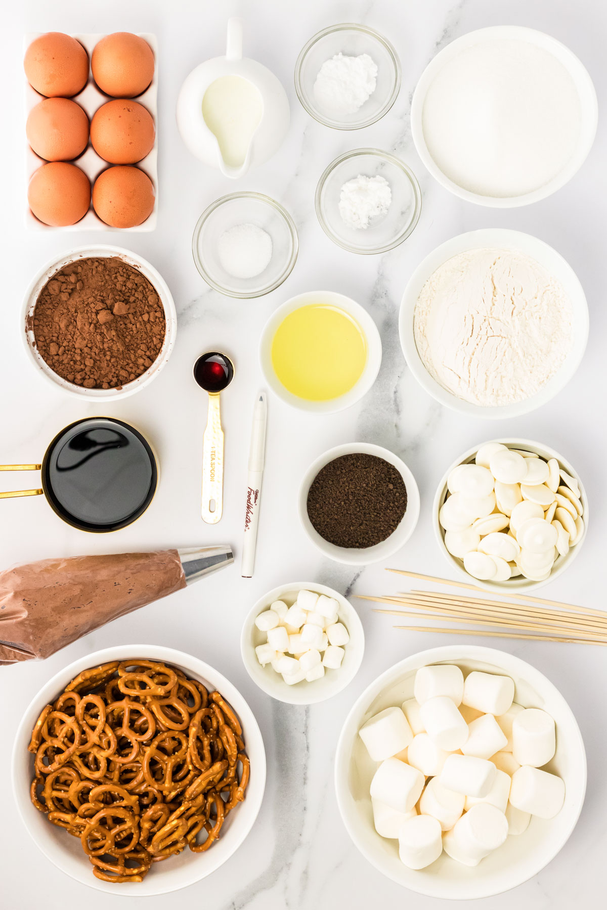 Overhead photo of ingredients to make skeleton cupcakes on a counter.