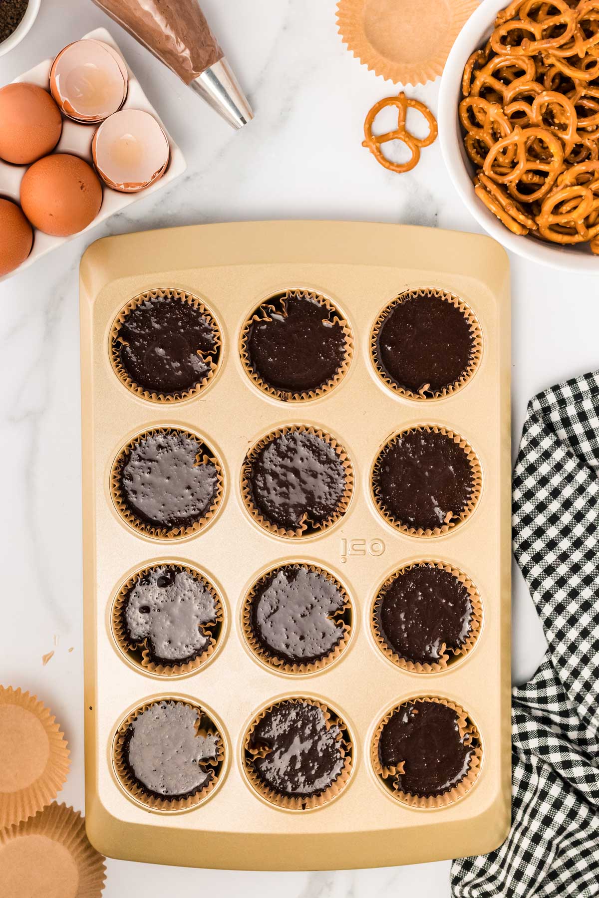 Chocolate cupcakes ready to bake in a pan.