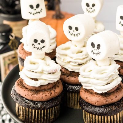 Skeleton Cupcakes on a black cake stand.